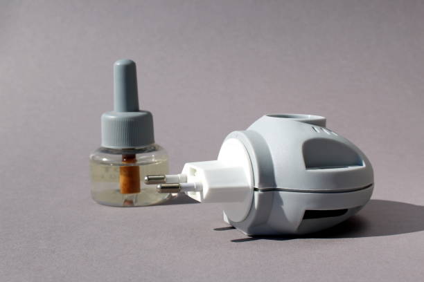 istock The adapter and liquid for mosquitoes are on a gray background. 1389061023