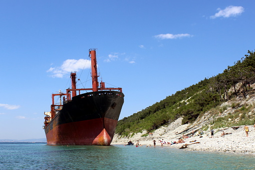 a multi-ton large ship is stuck on the seashore