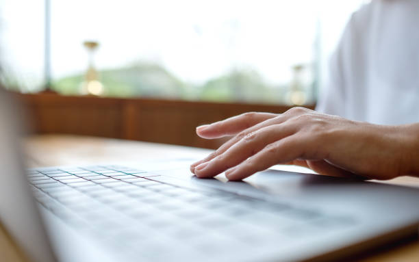 istock Closeup image of a woman working and touching on laptop computer touchpad 1389062008