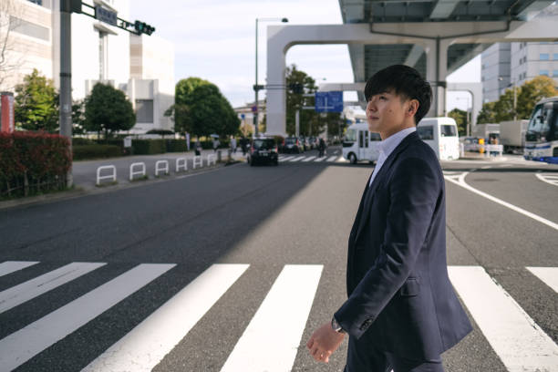 istock Businessman walking  on zebra crossing 1389063123