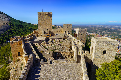 Jaen, Spain, November 13, 2021: Medieval castle of Santa Catalina on top of the mountain in sunny day. Jaen Spain.
