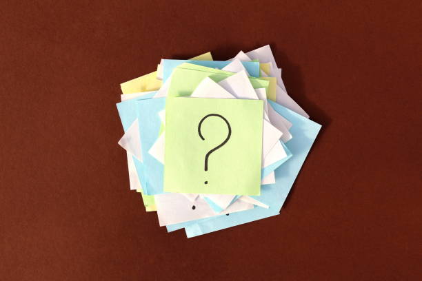 istock Stickers with question marks lie in a pile. 1389074836