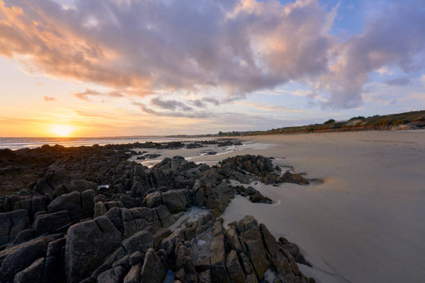 istock Sunset at the beach. Stones in the foreground. Sky for Copy space. 1389075432