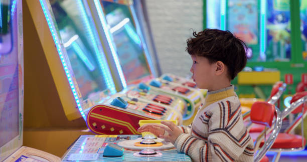 istock Asian little boy playing in electronic playground 1389075837