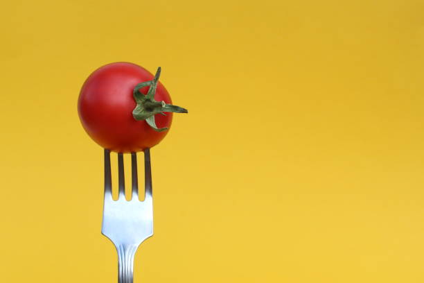 istock A red ripe tomato is impaled on an iron fork. 1389076598