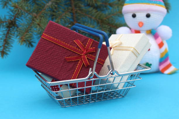 istock Gift boxes are in a miniature shopping basket. 1389076634