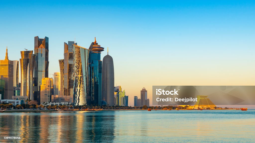 The Downtown Doha City Corniche Skyline at Twilight, Qatar Clear Sky Copy Space with Colourful Sunset Sky Qatar Stock Photo