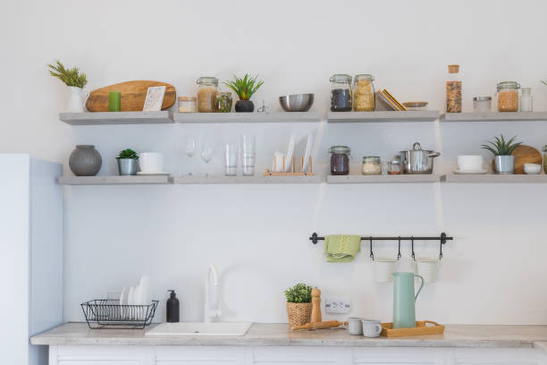 istock Modern kitchen with shelves, food, spice and dishes.kitchen corner with various cooking utensils including plants,wooden utensils ,glass container.loft interior of kitchen in apartment. 1389078114