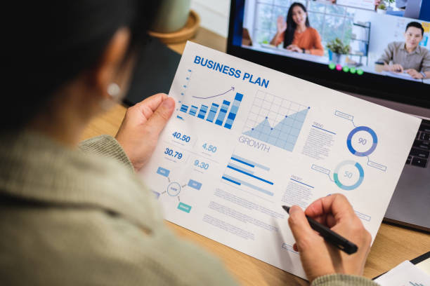 business planning work images asian woman video conference business meeting with colleague online with laptop at home asian woman video conference business meeting with colleague online with laptop at home business plan stock pictures, royalty-free photos & images