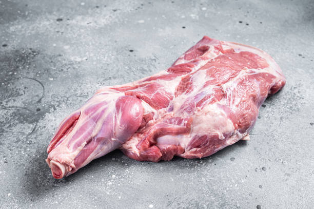 istock Raw lamb shoulder meat on butcher table. Gray background. Top view 1389081075