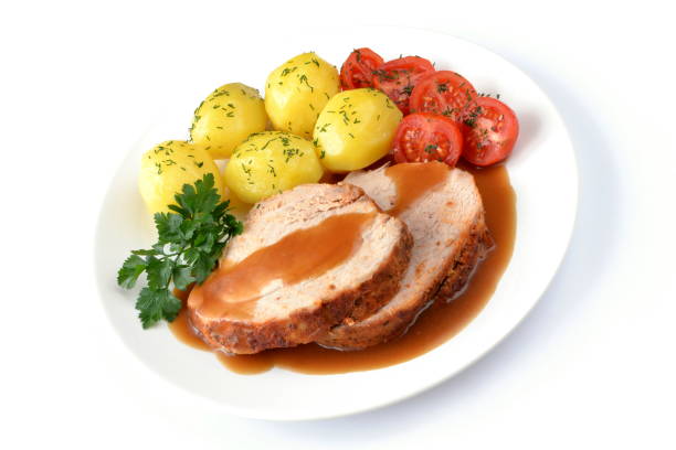 baked ham with potatoes and tomato