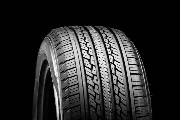 istock all-season new tire on a black background 1389087173