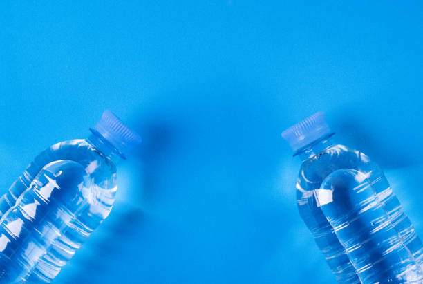 istock Two bottles of clean drinking water on blue 1389087386