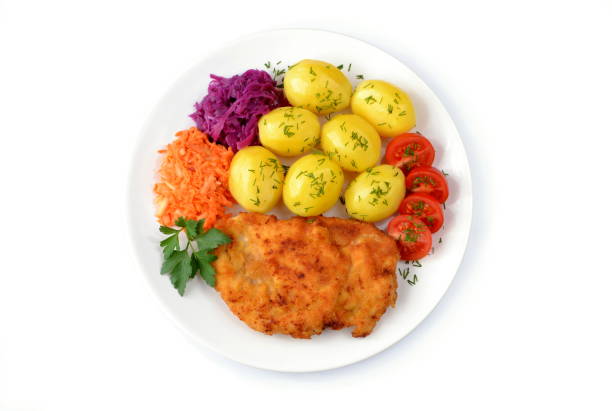 fried chicken fillet with potatoes, tomato and salads