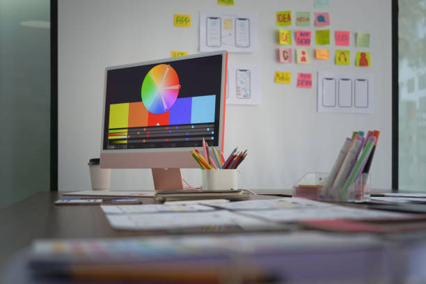 istock Creative designer workplace with computer pc, stationery and color swatches on wooden table. 1389088287