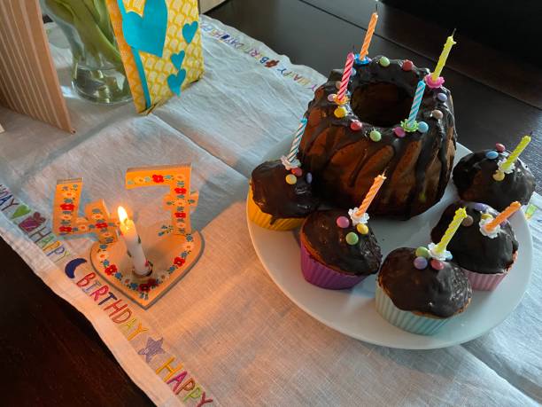 istock Birthday table with cake, candle and presents 1389091423