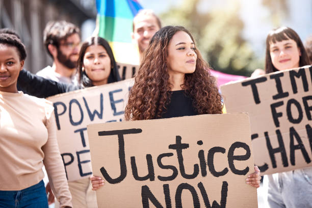 istock Shot of a group of young people protesting climate change 1389094795