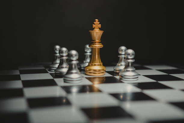 istock The golden chess king leads the silver chess pieces on the chessboard. 1389095049