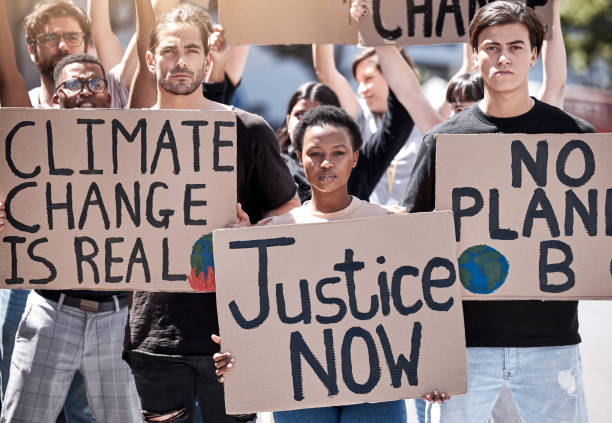 istock Shot of a group of young people protesting climate change 1389096411