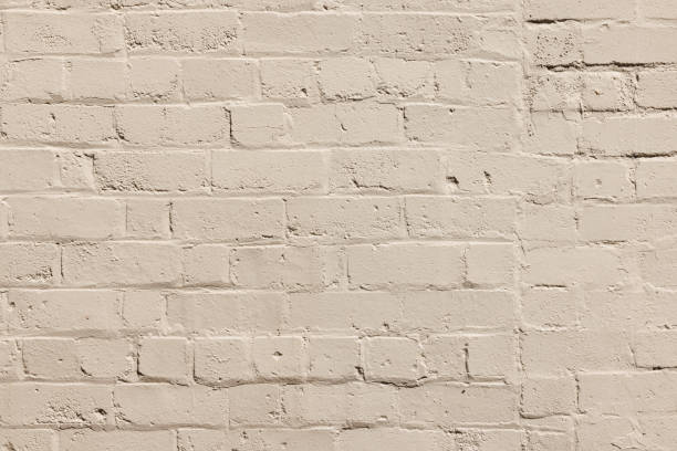 istock Part of a painted old beige brick wall 1389096548