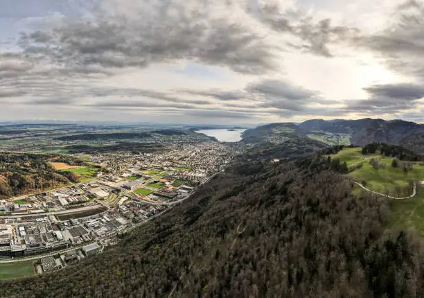 View of the city, Lake Biel and the Jura mountains from above the Bözingenberg mountain. also pictured is the city's industrial area and the A5 motorway junction