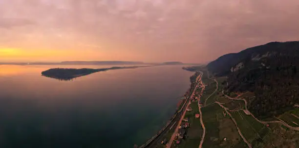 Aerial view with a colorful morning mood overlooking the lake, the St. Peter's Island, the lake shore and the nearby Jura Mountains. Morning mood near the city of Biel Bienne, canton Bern, Switzerland