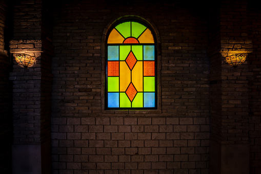 Mixture of circles and rectangles of glass that has been coloured by adding metallic salts during its manufacture. They are  held together  by strips of lead.