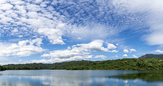 beautiful landscape reservoir and mountain , reflection of cloud on blue sky background , landscape Thailand