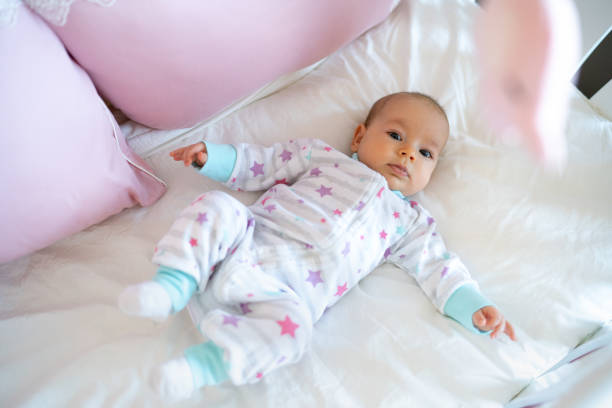 istock Baby girl lying in crib 1389099031