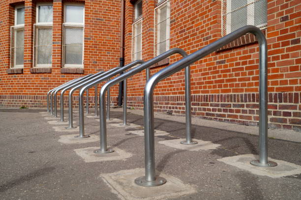 parking for bicycles and other vehicles near the building with brick walls. Barriers are made of bent metal parking for bicycles and other vehicles near the building with brick walls. Barriers are made of bent metal pavement ends sign stock pictures, royalty-free photos & images