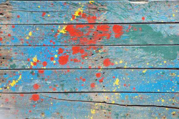 istock old boards stained with multi-colored paints. Used as background... 1389100301