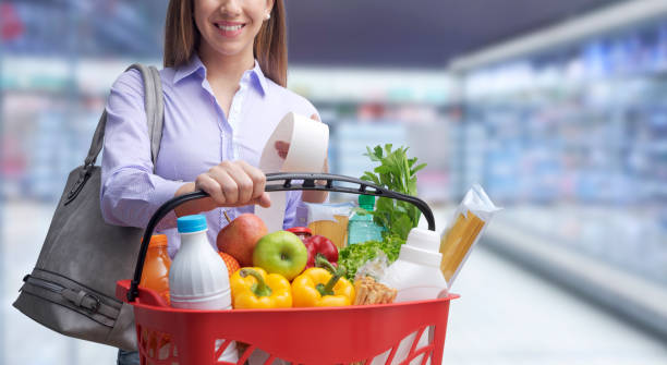 istock Smiling woman doing grocery shopping 1389103996
