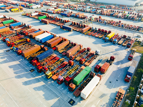 Aerial view of container chassis trailer truck and containers  in the port.