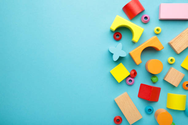 istock Multicolored blocks of the children's constructor lie on blue background. Space for text 1389111126