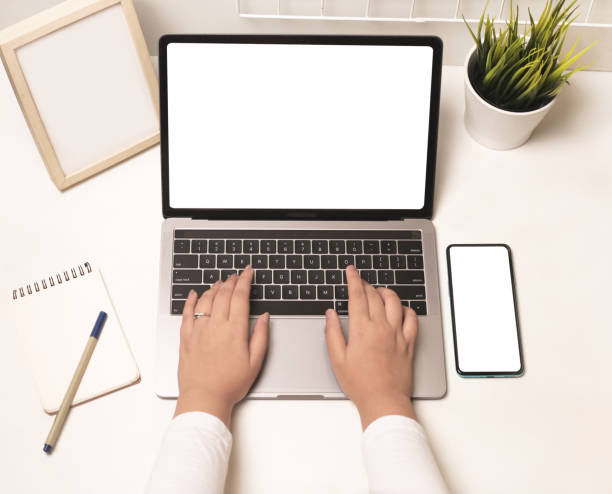 istock Indian business women using laptop and mobile with blank screen on it. Mock up screen on laptop and phone. 1389111843
