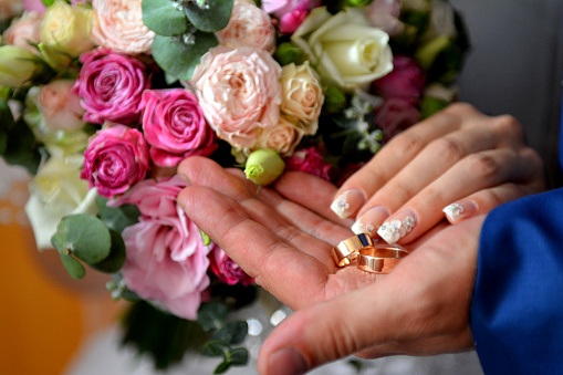 wedding wedding rings hands bouquet flowers. High quality photo