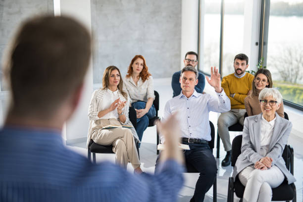 istock Large group of entrepreneurs having a seminar in a board room. 1389112250