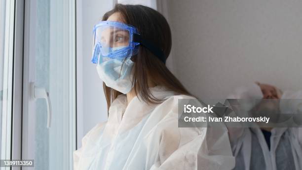 Tired Paramedics After A Shift In The Infectious Diseases Department With Coronovirus Patients Doctors Are Dressed In Protective Suits Masks And Goggles Hard Work For Medical Staff Stock Photo - Download Image Now