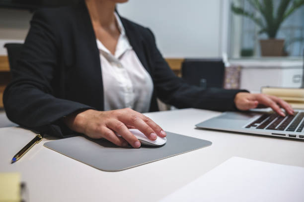 istock Crop businesswoman using wireless mouse 1389113524