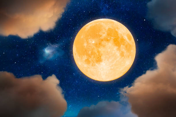 Yellow moon Big yellow full moon up in the sky surrounded by clouds. full moon stock pictures, royalty-free photos & images