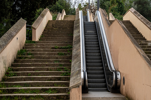 Stairs with vegetation that has grown on the steps and escalators on Montjuïc mountain, Barcelona, Spain