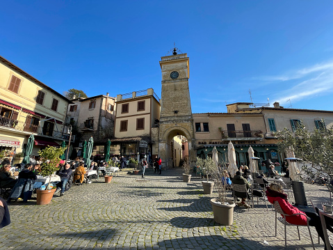 Town of Anguillara, on the lake of Bracciano, northwest of Rome, Italy. Some people in the shot. Sunlight, outdoors.