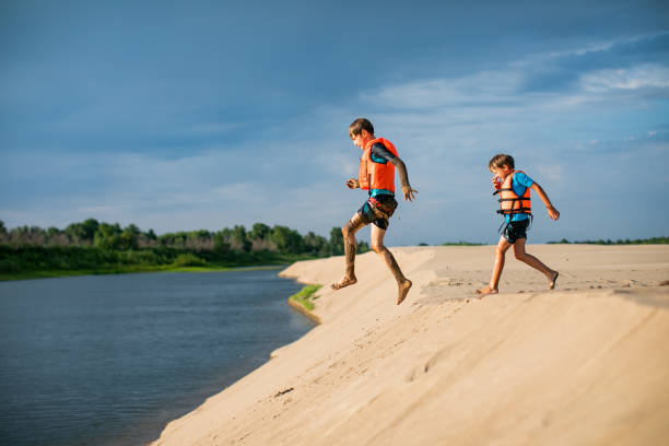 Preschool boys having fun in sand dunes