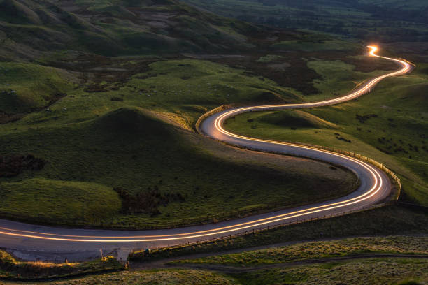 light trails on british countryside road, peak district, uk. - road stok fotoğraflar ve resimler