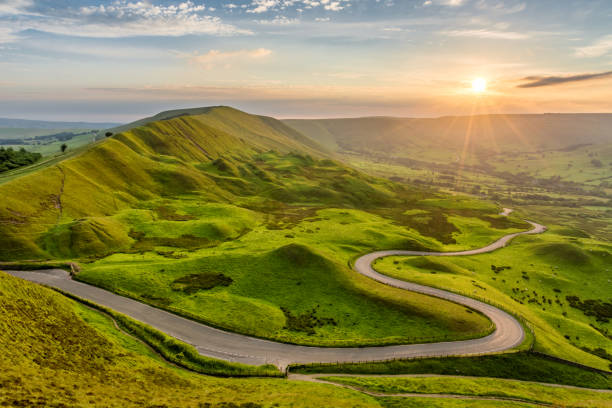 istock Winding Road In The Peak District Leading To Summer Sunset. 1389125164