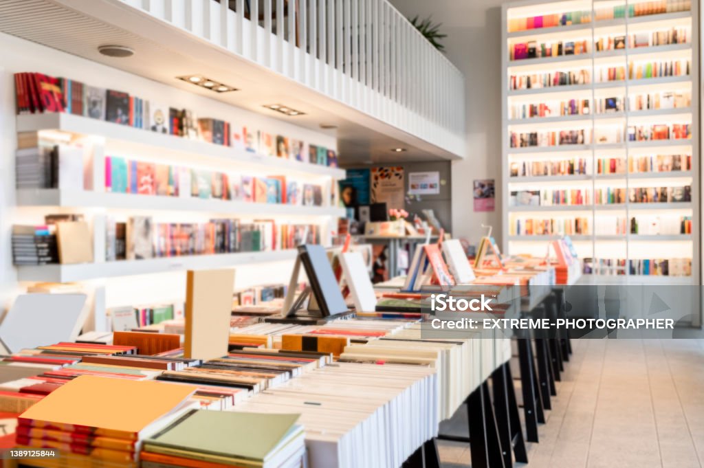 Everyday life is better when you enter a bookstore like this one full of books A bookstore very bright and modern with white shelves full of books seen during day light. Bookstore Stock Photo