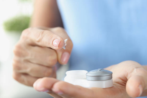 istock Fingertip contact lenses and storage box closeup 1389126113