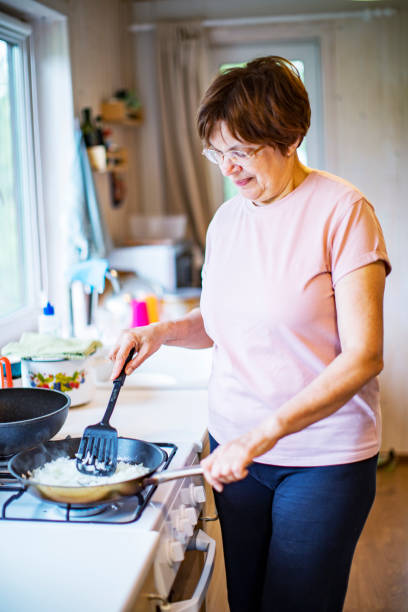istock Active senior woman cooking vegetables at home 1389126389