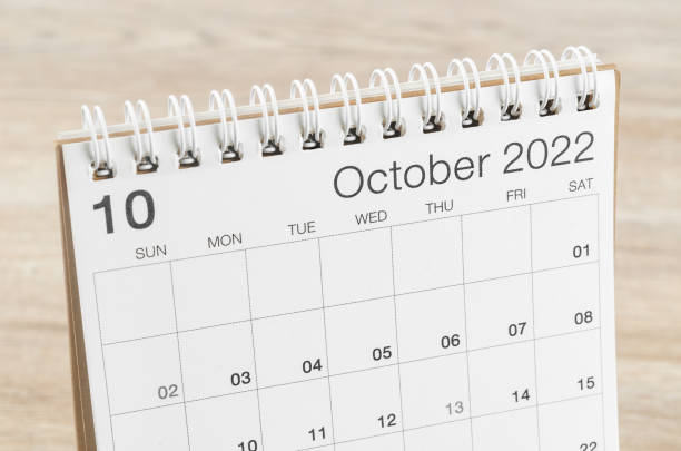 istock October 2022 desk calendar on wooden background. 1389126426