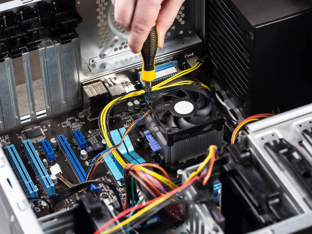istock Installation of ventilation on the processor cooling system. Repair of computers, assembling a personal computer. Assembling a PC. Installing hardware components. 1389128032
